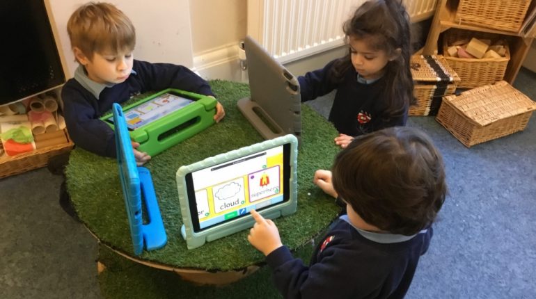 Children working with tablets to study