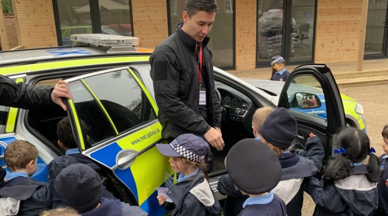 Member of police force talking to the children