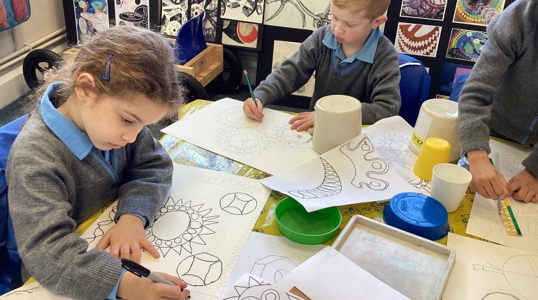 Children drawing mandalas and patterns