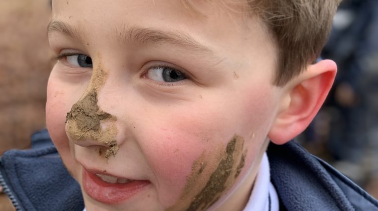 Child with mud on his face