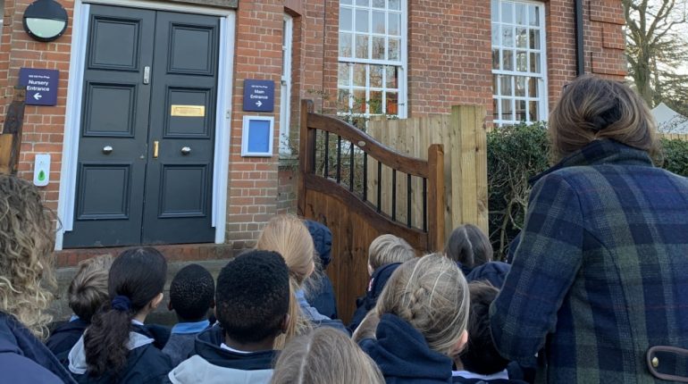 Students waiting at the front of Mill Hill school