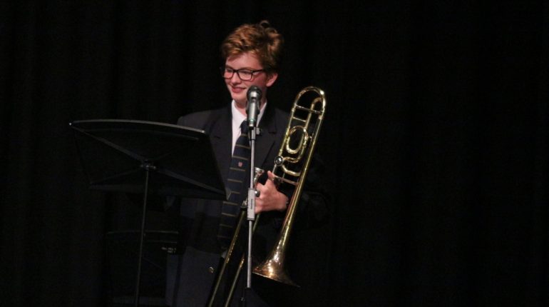 student holding a trumpet