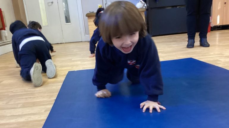 child crawling across the mat