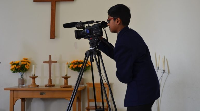 student using a video camera to work