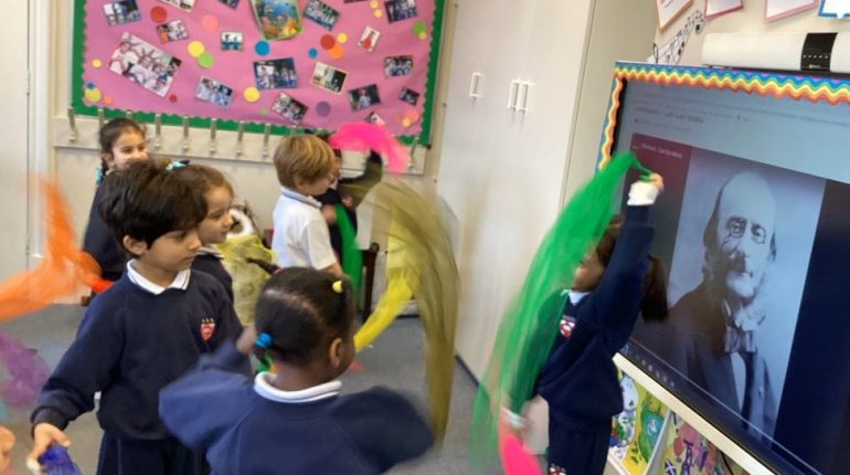 children playing with fabric in a music lesson