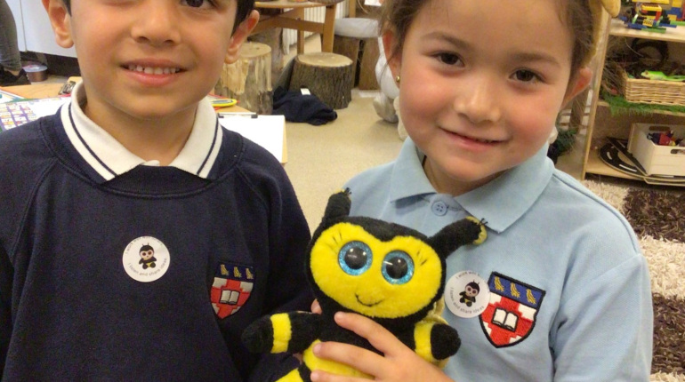 two children holding a bumble bee toy