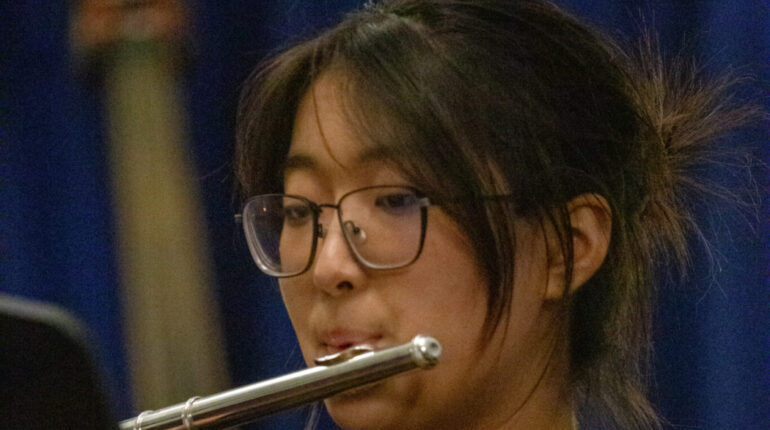 student playing the flute