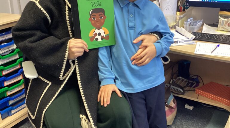 student and parent holding a book