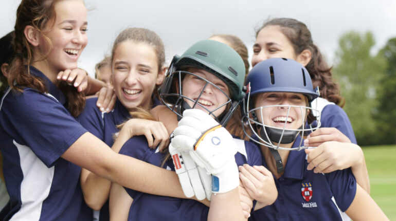 group of girls in cricket gear
